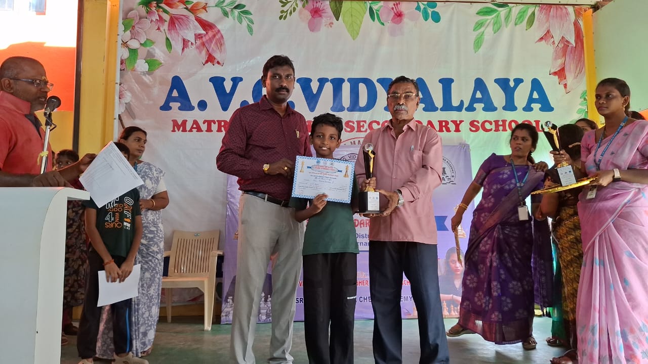 Student receiving trophy at A.V. Vidyalaya event